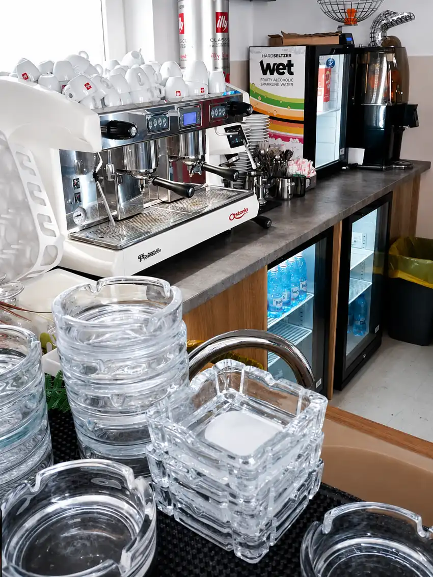 Espresso machine, cups and chilled drinks at the coffee bar of Pensiunea Elis